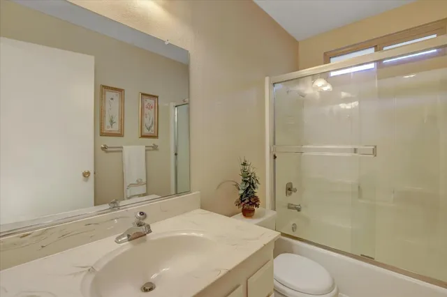 a view of a house with porch and wooden fence
