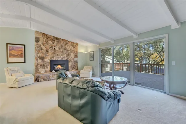 a view of a dining room with furniture and a large window