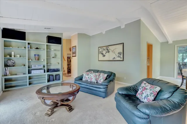 a kitchen with a sink window and cabinets