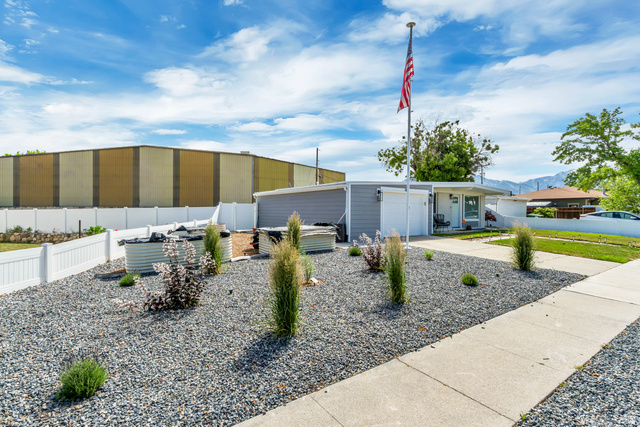 48 Moon Ridge Drive Murray, UT 84107 - Photo 26 of 30 Front exterior showcasing a gravel landscape with established plantings and a concrete pathway
