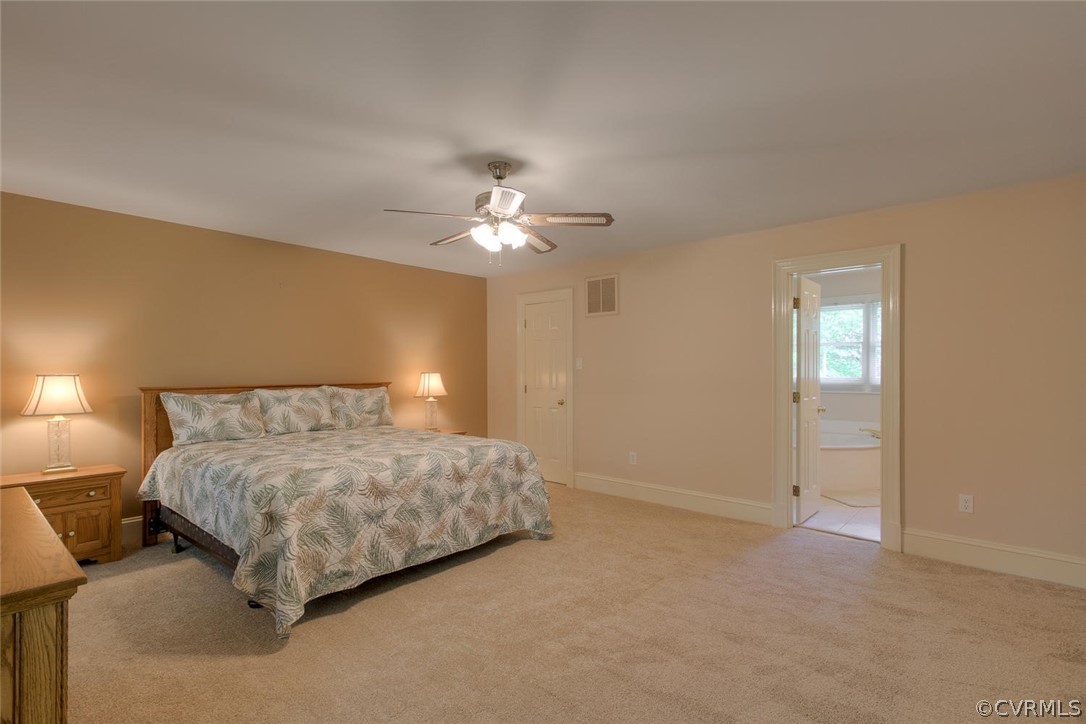 9211 Cattail Road Chesterfield, VA 23838 - Photo 19 of 37 a bedroom with a bed and a chandelier