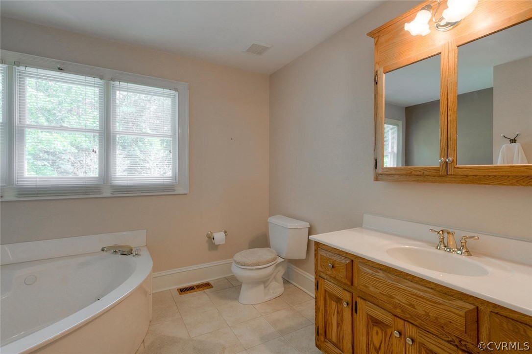9211 Cattail Road Chesterfield, VA 23838 - Photo 20 of 37 a bathroom with a granite countertop toilet a sink and a bathtub