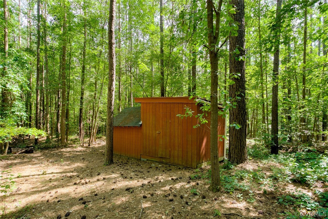9211 Cattail Road Chesterfield, VA 23838 - Photo 34 of 37 a backyard of a house with lots of green space and garden view
