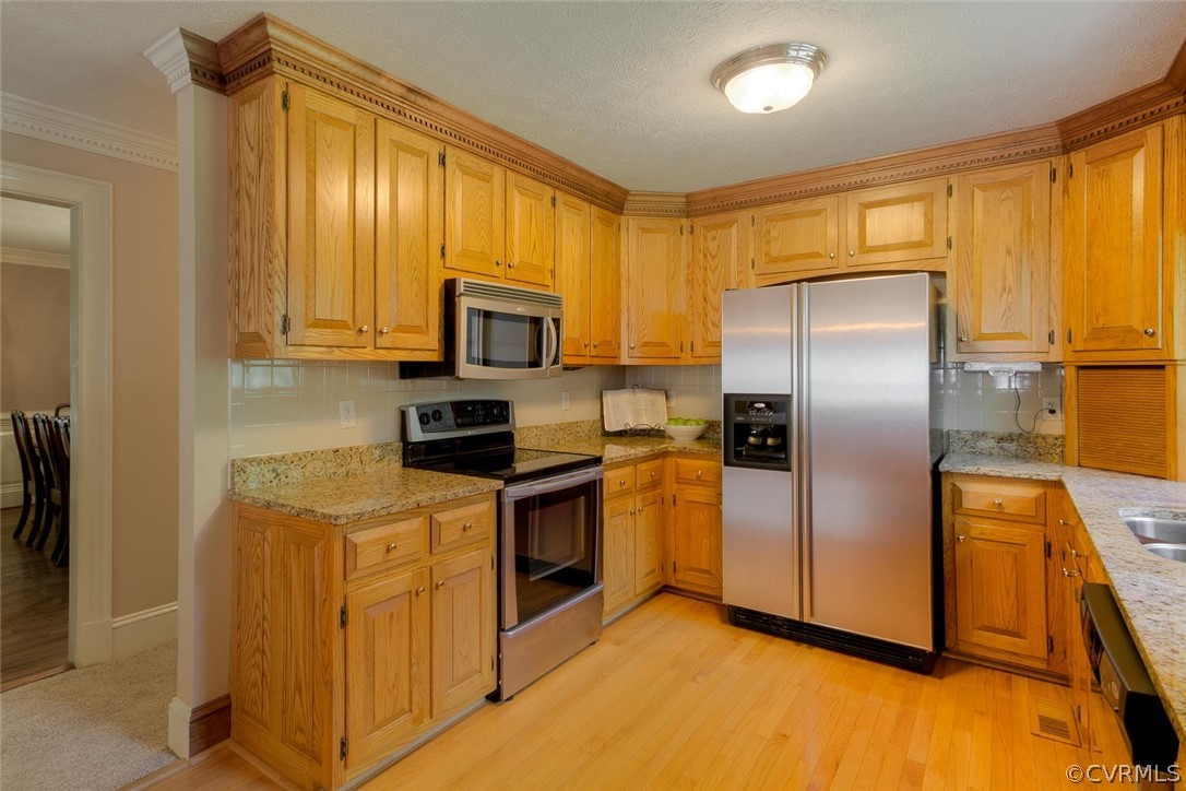 9211 Cattail Road Chesterfield, VA 23838 - Photo 7 of 37 a kitchen with stainless steel appliances granite countertop a refrigerator a stove a sink a washer dryer and a refrigerator