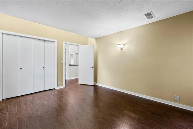 a view of an empty room with wooden floor