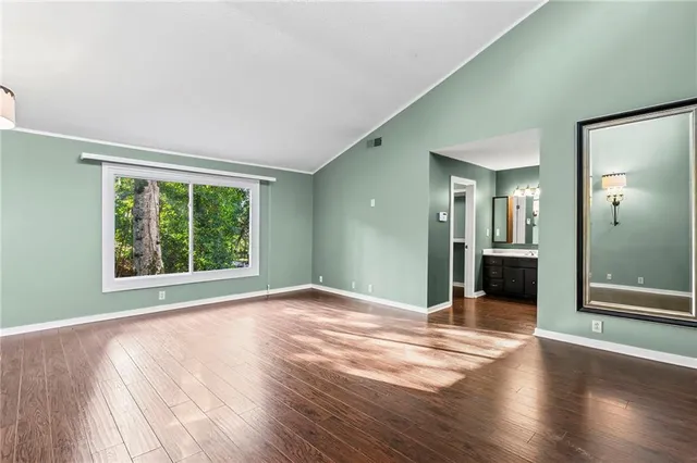 a view of a room with wooden floor
