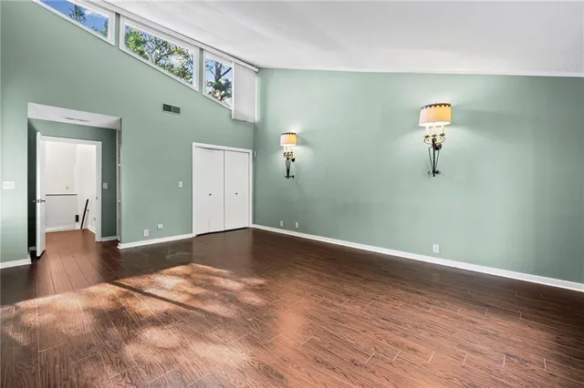 a view of walk in closet with empty racks