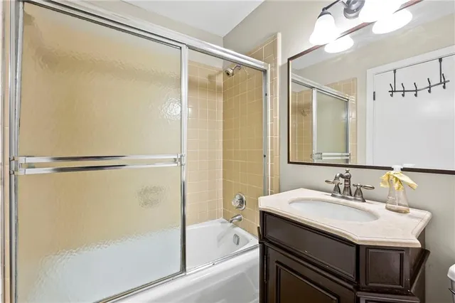 an empty room with wooden floor and natural light