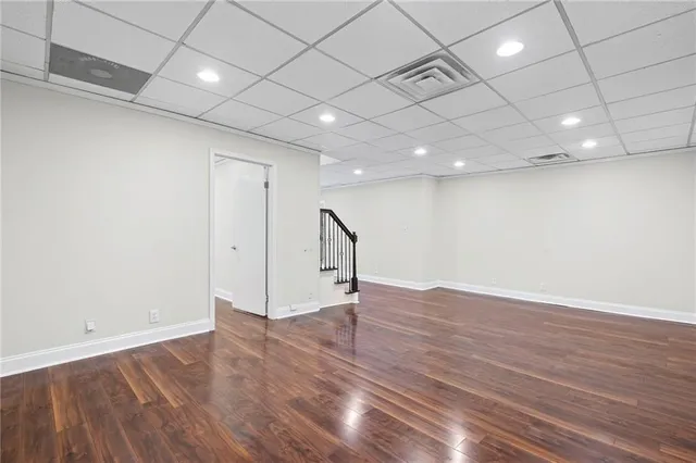 a view of a room with wooden floor