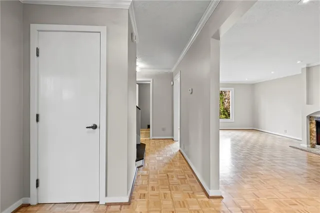 a view of a hallway with wooden floor