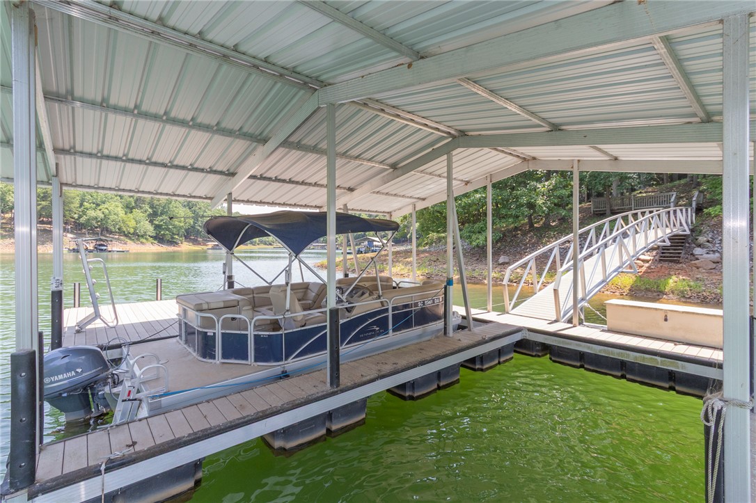 202 Plantation Point Anderson, SC 29625 - Photo 46 of 48 A private boat dock with a covered slip and access ramp offers seamless lake enjoyment.