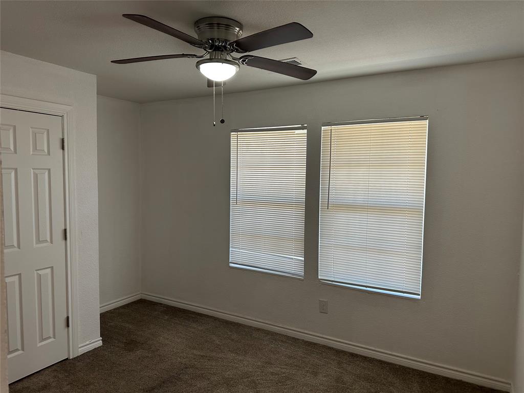 412 South Park Street Terrell, TX 75160 - Photo 3 of 15 an empty room with a window and a fan