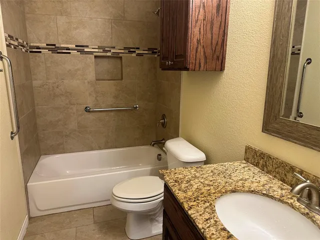 a bathroom with a sink a toilet and bathtub