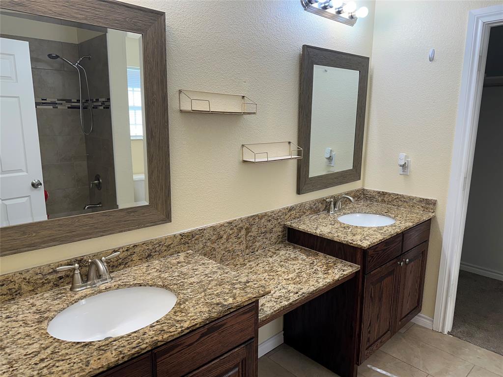 412 South Park Street Terrell, TX 75160 - Photo 10 of 15 a bathroom with a granite countertop sink and a mirror
