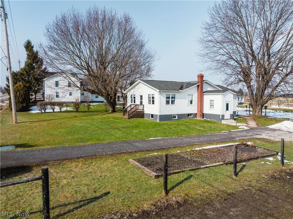 16350 Nauvoo Road Middlefield, OH 44062 - Photo 4 of 50 View of front of home featuring a front lawn, a chimney, and a residential view