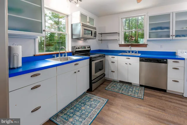 a kitchen with refrigerator and window