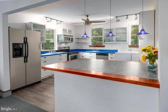 a kitchen with a wooden floor and window