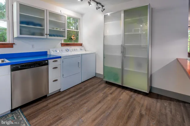 a dining room with furniture a chandelier and window
