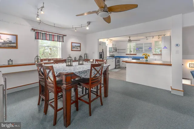 a view of a dining room with furniture and window