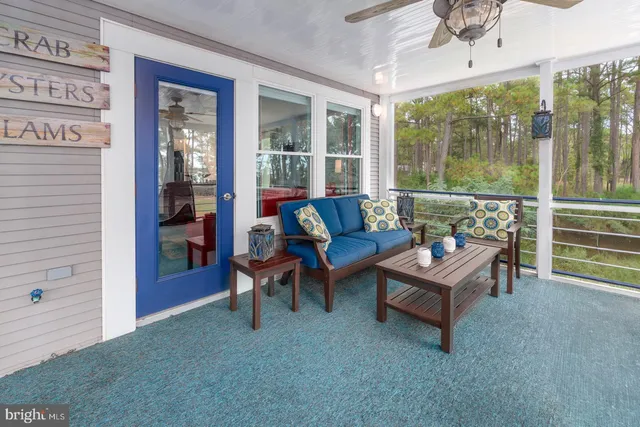 a dining room with furniture large windows and a rug