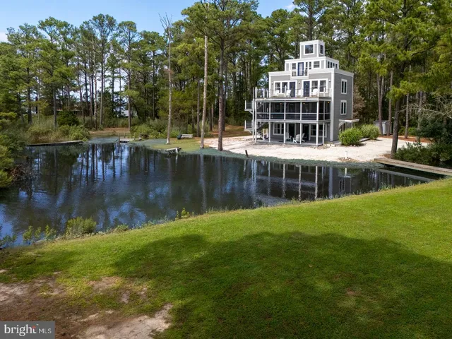 a view of a house with a yard and sitting area