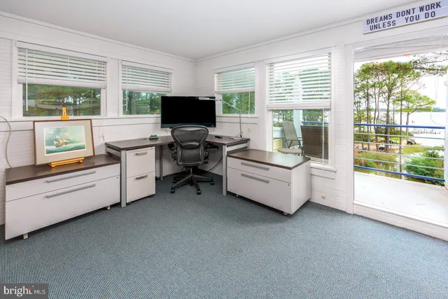 a bedroom with a bunk bed and a window
