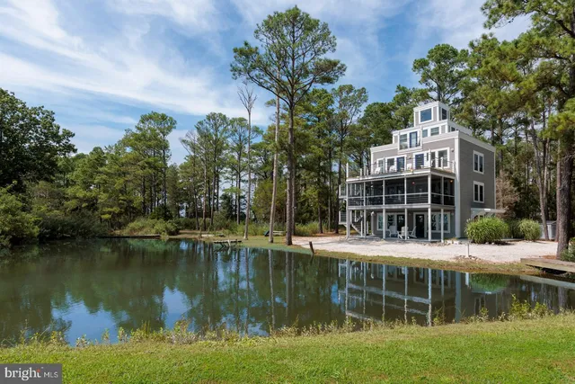 a view of house with river in front and trees