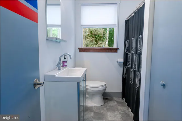 a bathroom with a toilet and a tub