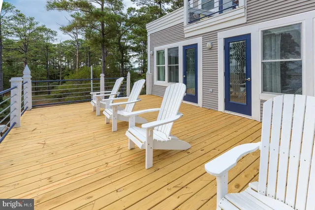 a view of a chairs and table on the wooden deck