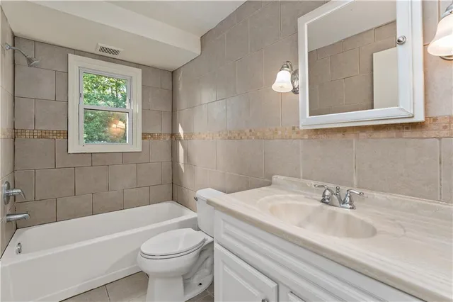 a bathroom with a sink a toilet and a bathtub