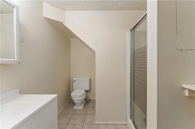 a bathroom with a white toilet and a sink