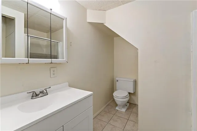 a bathroom with a sink toilet and a mirror