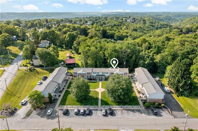 an aerial view of a residential houses with outdoor space and street view