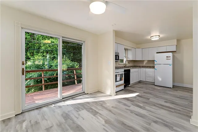 a view of kitchen with wooden floor and electronic appliances