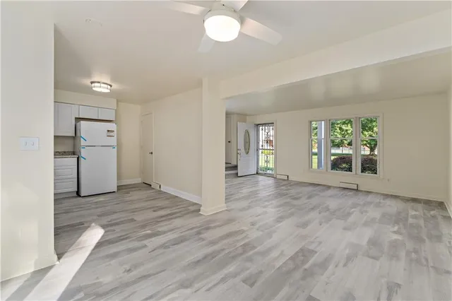 an empty room with windows and entrance