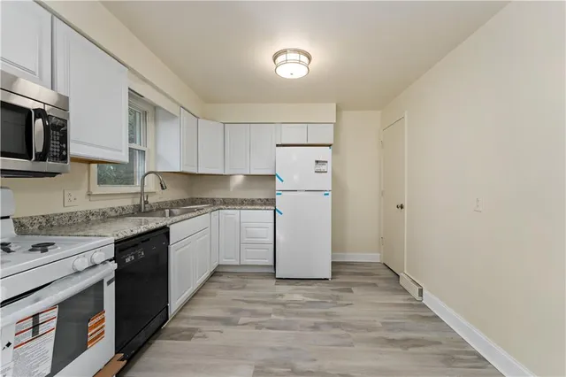 a kitchen with a sink stove and refrigerator
