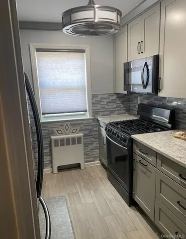 a kitchen with granite countertop a stove and a sink