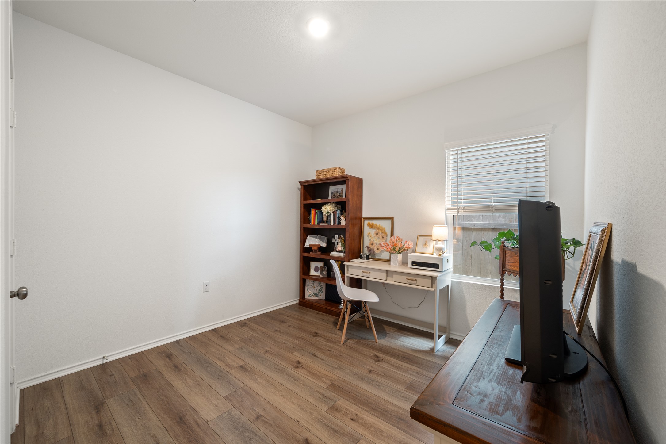 14404 Berning Road Manor, TX 78653 - Photo 26 of 38 A well-lit bonus room features wood flooring and a window offering natural light.