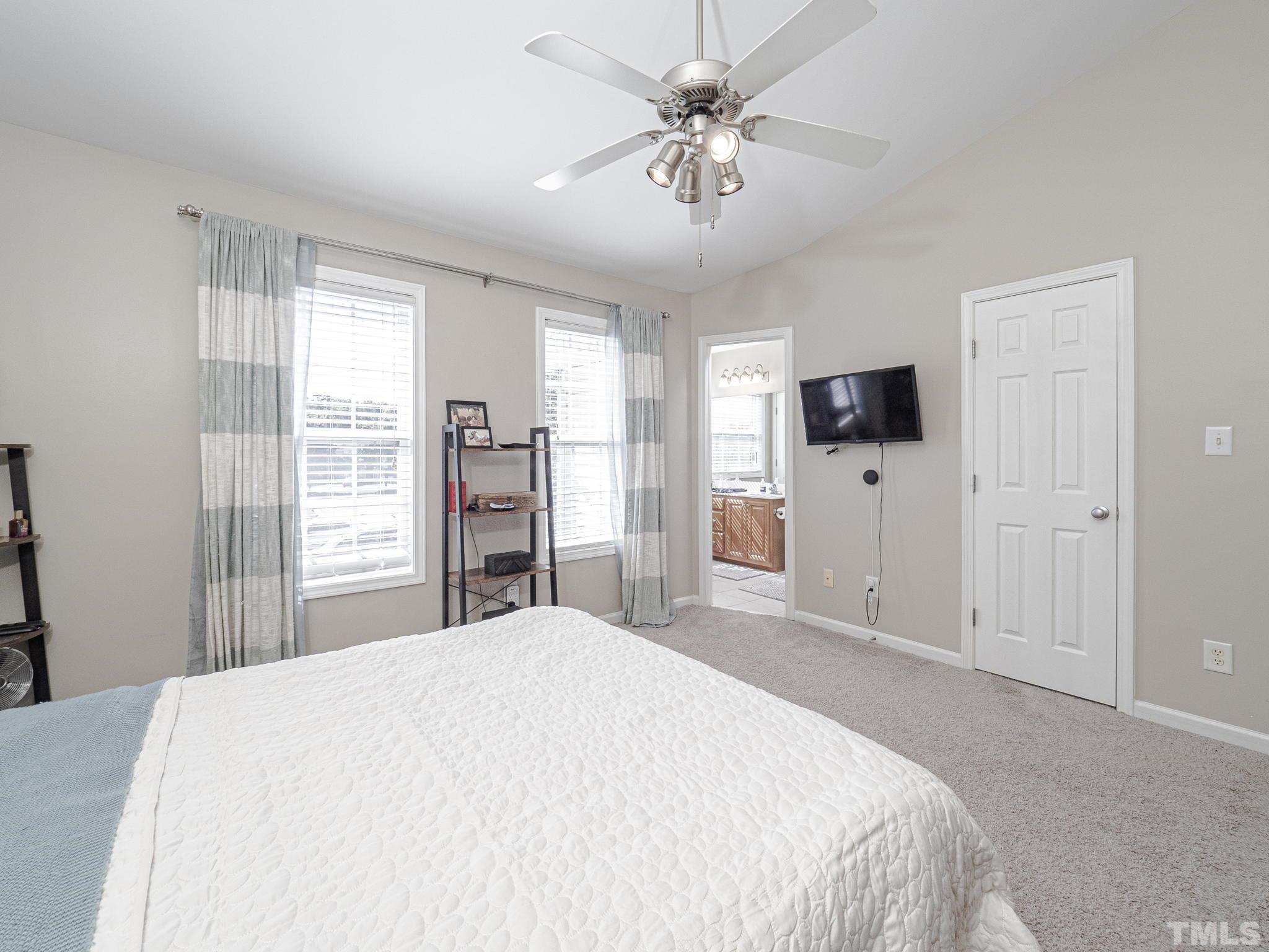 2031 Rivergate Road, Unit 106 Raleigh, NC 27614 - Photo 10 of 11 a bedroom with a bed and a flat tv screen
