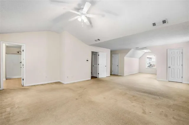 an empty room with fan and a ceiling fan