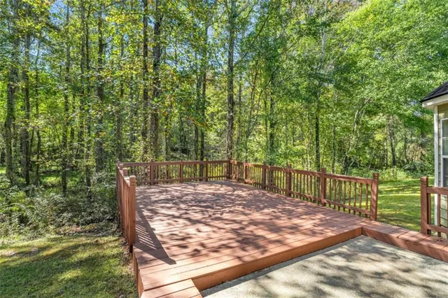 a view of a backyard with wooden fence