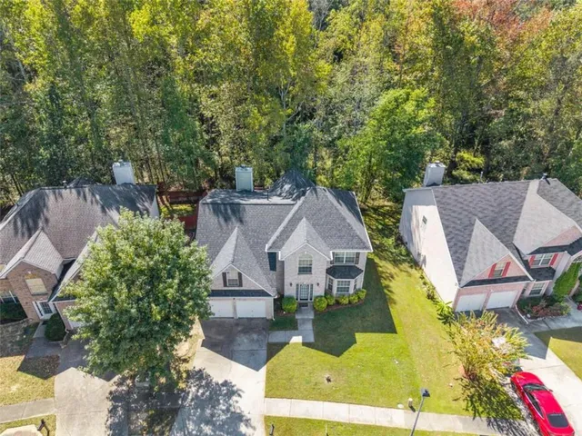 an aerial view of a house with swimming pool