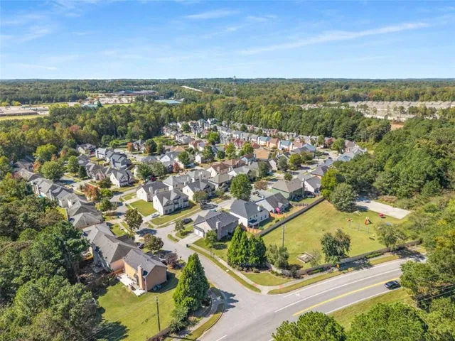 an aerial view of residential building and lake
