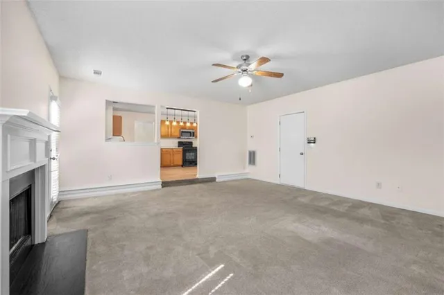 a view of empty room with a fireplace