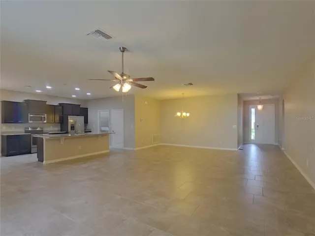 a view of a kitchen with a sink and a chandelier