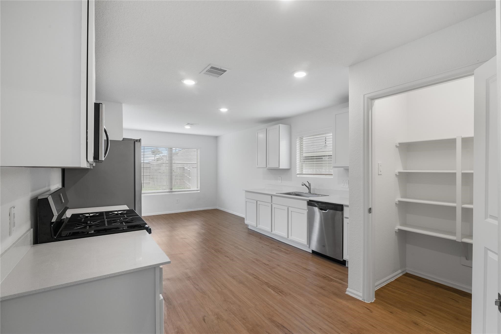 3034 Twisted Myrtle Drive Conroe, TX 77301 - Photo 11 of 27 a kitchen with a stove and a refrigerator