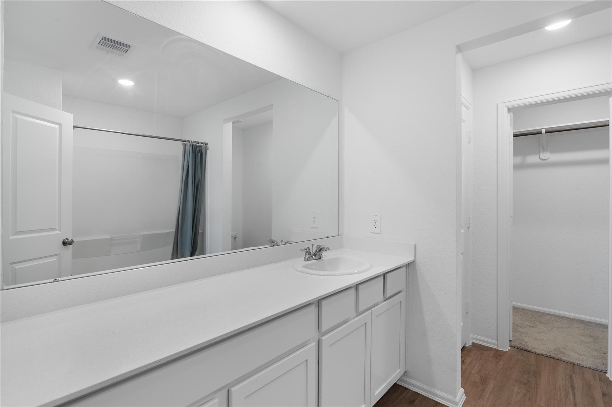 3034 Twisted Myrtle Drive Conroe, TX 77301 - Photo 14 of 27 a bathroom with a sink and a mirror