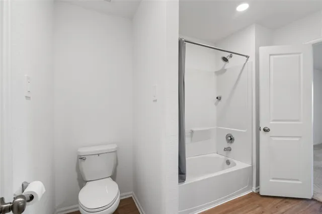 a bathroom with a toilet and a bathtub