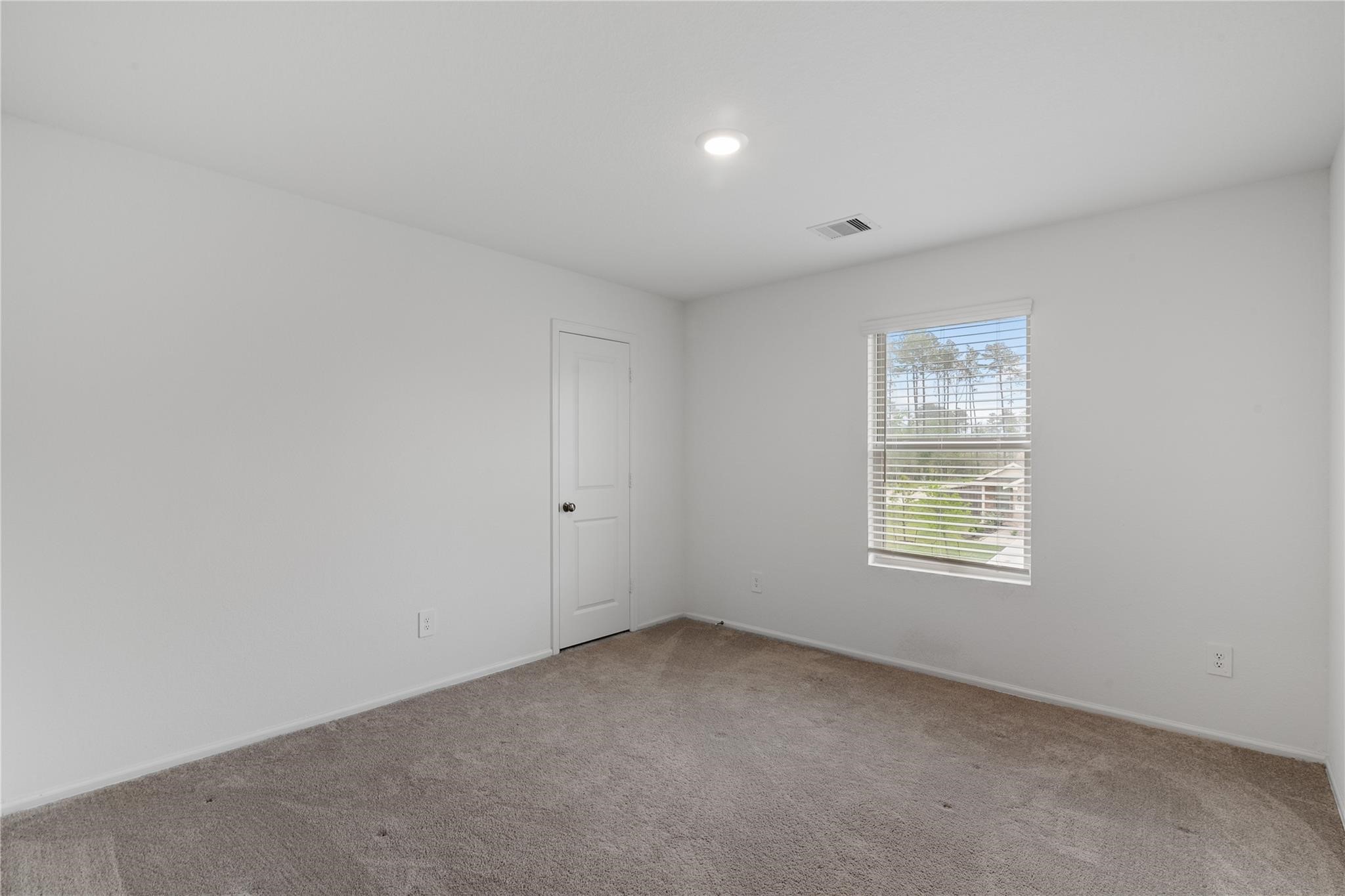 3034 Twisted Myrtle Drive Conroe, TX 77301 - Photo 18 of 27 an empty room with a window
