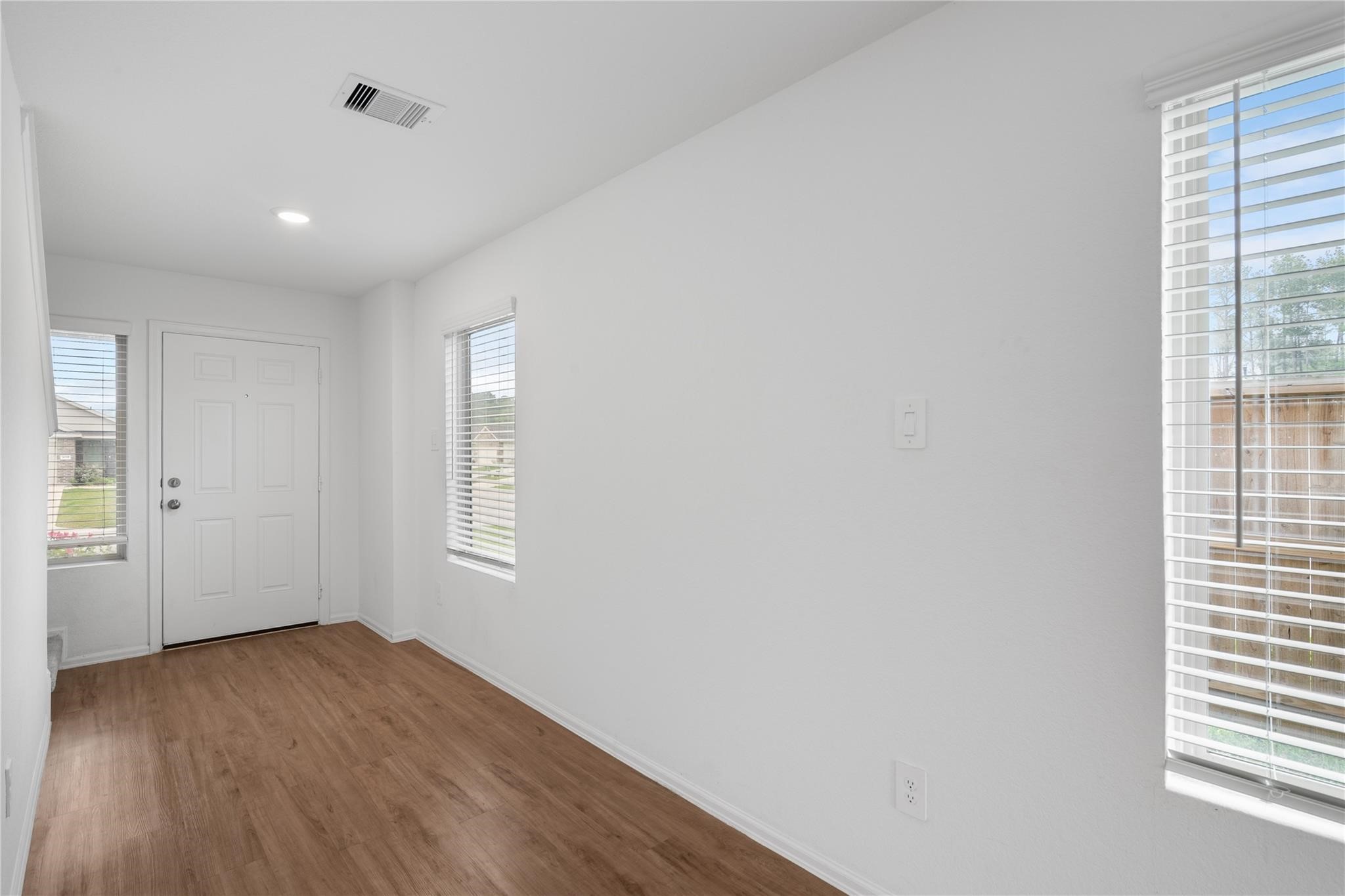 3034 Twisted Myrtle Drive Conroe, TX 77301 - Photo 2 of 27 an empty room with wooden floor and windows